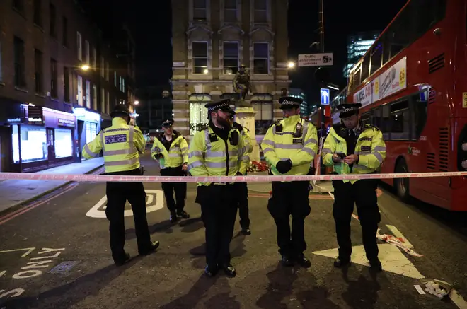 Police officers cordon off the scene in the south side of London Bridge.