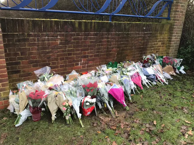 Floral tributes are laid outside Debden Park High School