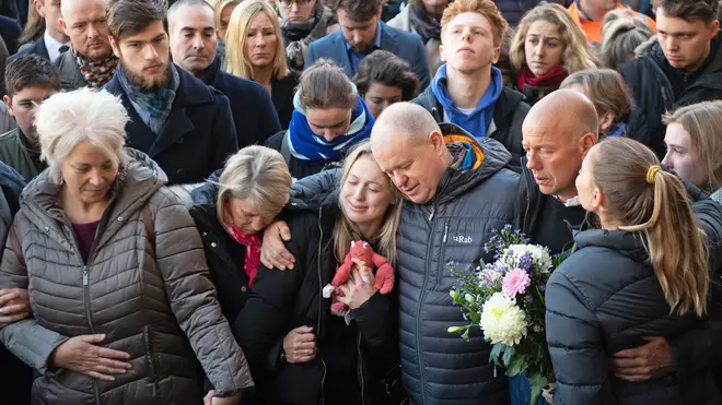 David Merritt (centre) with mourners at a vigil for his son