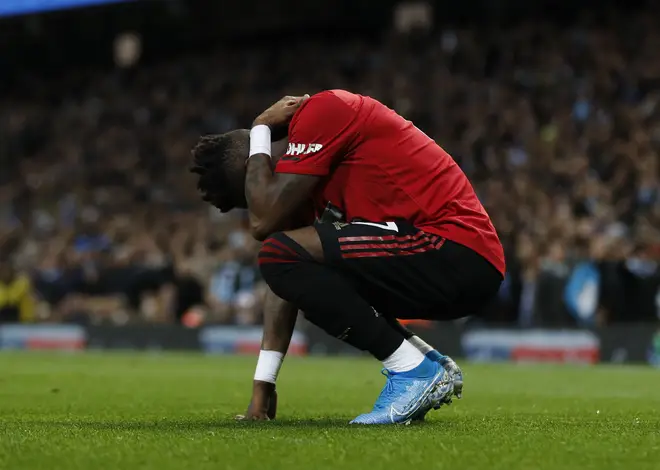 Fred of Manchester United reacts to objects being thrown at him during the Manchester Derby