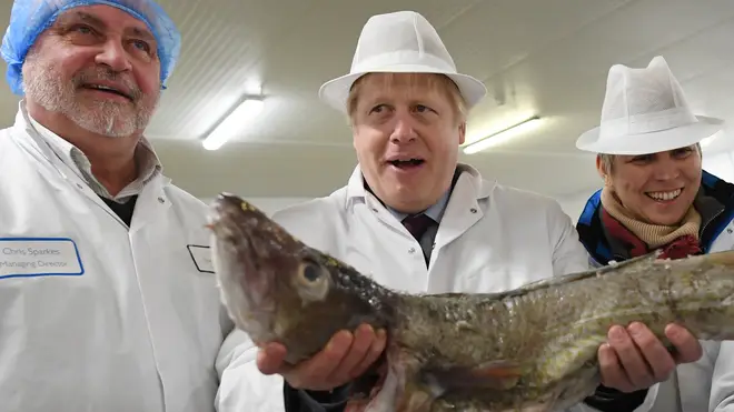 Boris Johnson holds a cod