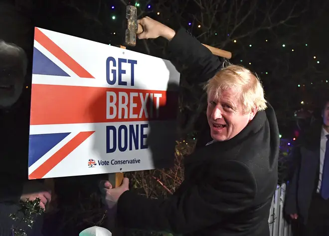 Boris Johnson with a Get Brexit Done sign