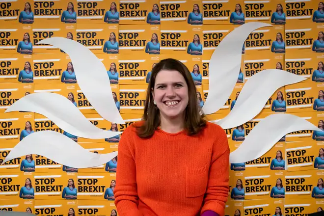 Jo Swinson poses in front of her party's Stop Brexit logo