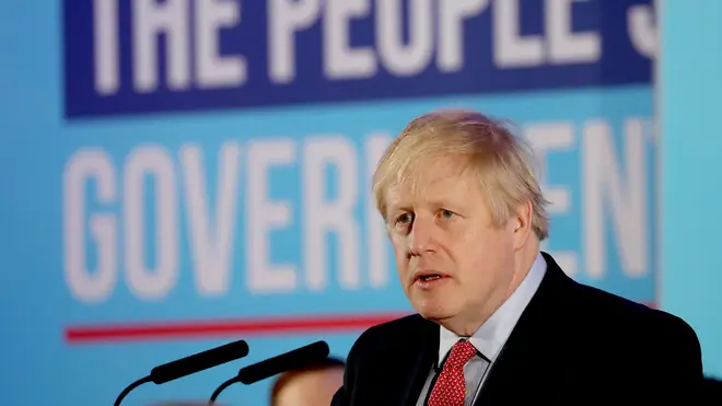 Mr Johnson was standing in front of a sign that read "The People&squot;s Government"