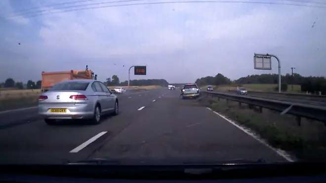 The moment after the Mini was sent flying across the motorway after a white Mercedes smashed into it.