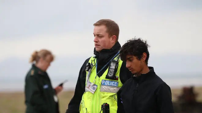 Migrants being led away by Border Force agents on a beach near Dover, as a total of 39 were detained after four boats were intercepted attempting to cross the English Channel in November