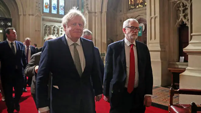 Boris Johnson and Jeremy Corbyn walk side-by-side through the Commons.