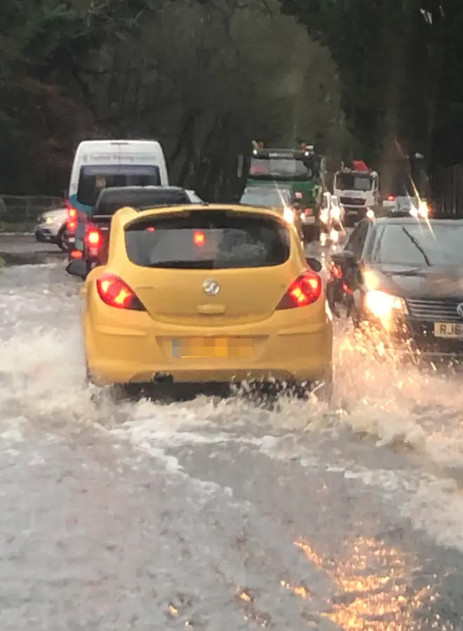Traffic makes its way through floods near the M23