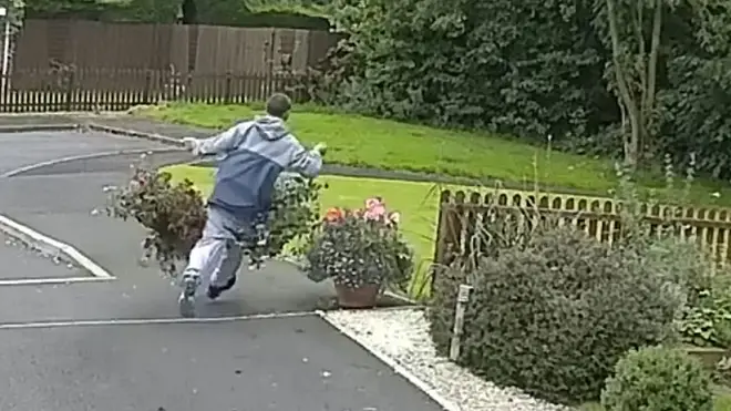 Man has a trouser mishap as he steals two big hanging baskets
