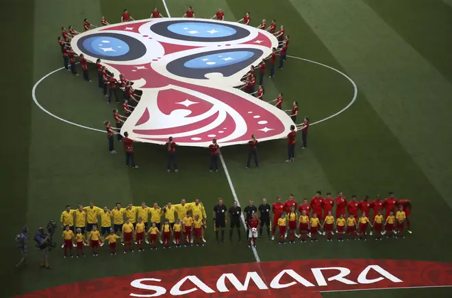 The England football team stand besides the Swedish team ahead of their quarterfinal match in the World Cup