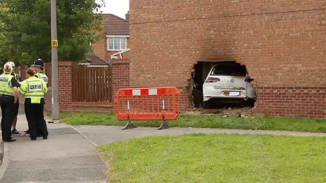 This pictures show the horror crash as a car ploughed through the wall of a house