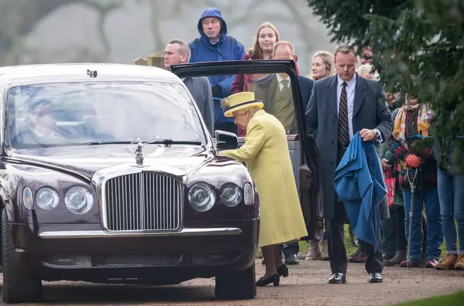 The Queen steps into a vehicle after attending the morning service
