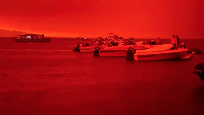 The sky was blood-red as the fire approached the coast