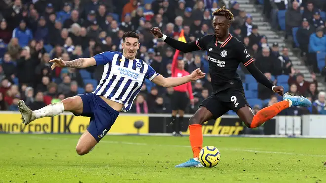 Chelsea's Tammy Abraham (right) and Brighton and Hove Albion's Lewis Dunk battle for the ball