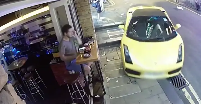 The supercar narrowly avoided a man sitting outside a bar