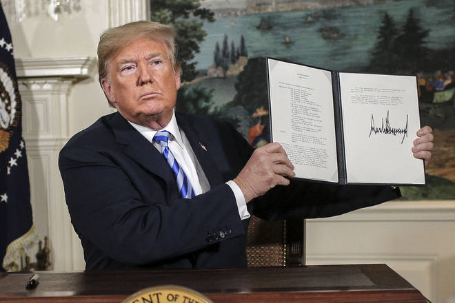 President Donald Trump holding a memorandum on Iran nuclear deal in 2018