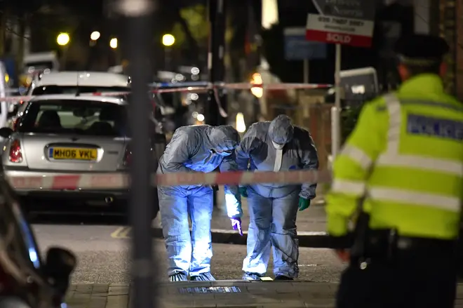 Forensics officers at the scene of the fatal stabbing