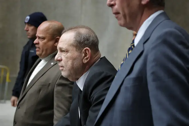 Harvey Weinstein, third from left, leaves court in New York