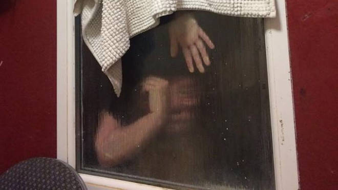 The woman stuck upside down in a window after trying to retrieve her poo