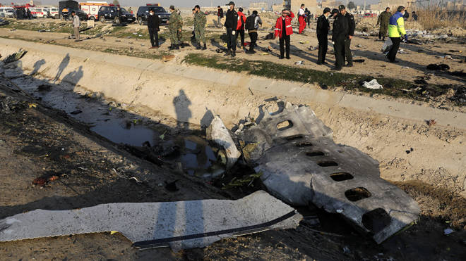 Investigators examine the wreckage of the downed plane