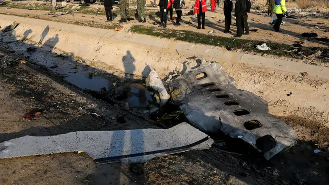 Investigators examine the wreckage of the downed plane