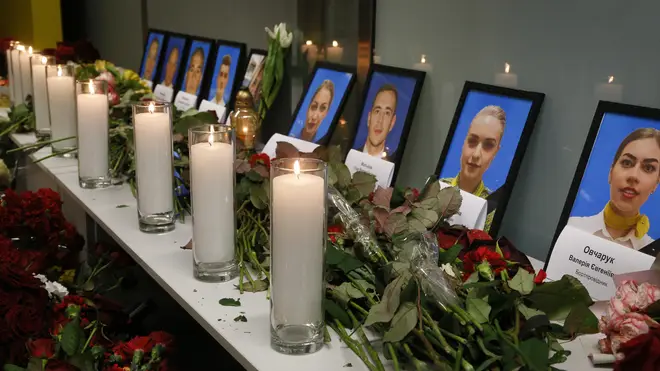 Flowers and candles are placed in front of portraits of the flight crew members of the Ukrainian 737-800 plane that crashed on the outskirts of Tehran