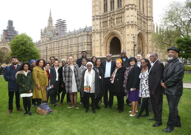 David Lammy MP (centre) with members of the Windrush generation following a personal apology from immigration minister Caroline Nokes, as they visited Parliament for the first time since the scandal forced the home secretary to resign.