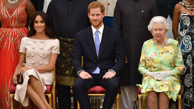 Meghan Markle, Prince Harry and the Queen pictured together in 2018 at the Queen's Young Leaders Awards Ceremony at Buckingham Palace, London