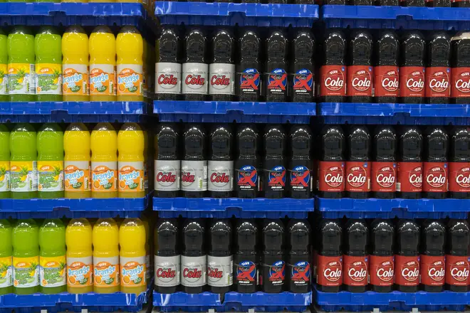 Plastic bottles of fizzy drinks on sale in a supermarket