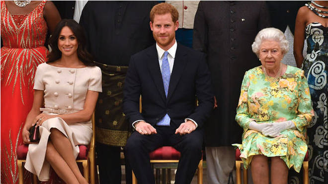 Meghan Markle, Prince Harry and the Queen pictured together in 2018 at the Queen's Young Leaders Awards Ceremony at Buckingham Palace, London.