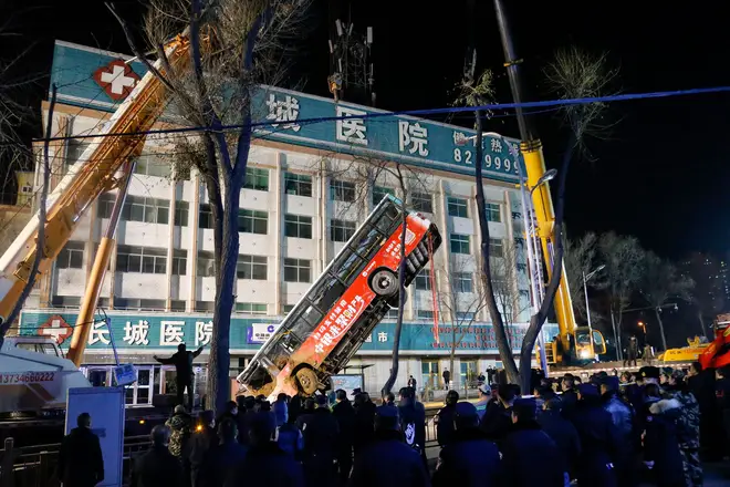 A bus is lifted out after a road collapse in Xining in China's northwestern Qinghai province