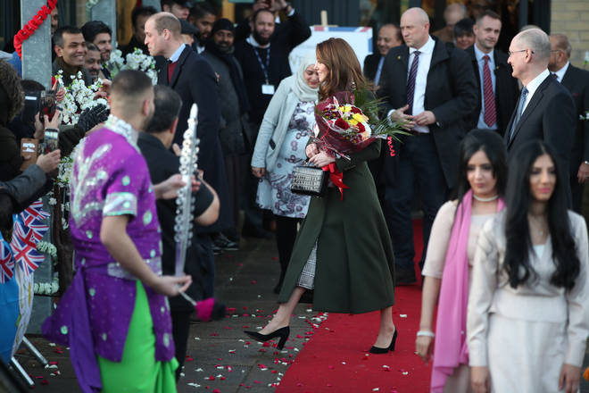Kate was given a bunch of flowers by a young girl