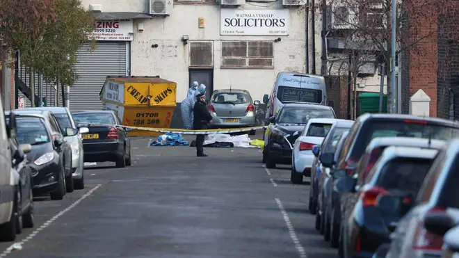 Police at the scene where three men died in Seven Kings in London