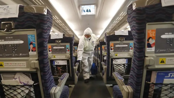 A worker disinfectants a train as a precaution against the coronavirus at Suseo Station in Seoul, South Korea