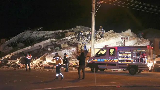 Rescue workers search a collapsed building in Sivrice