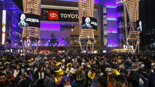Mourners gather outside the Staples Center in LA