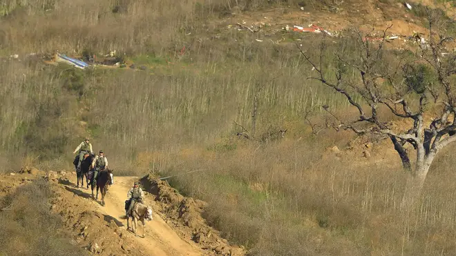 Police officers on horseback are patrolling the area to deter looters