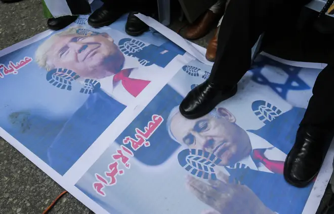Palestinian protesters stamped on pictures of Trump and Netanyahu