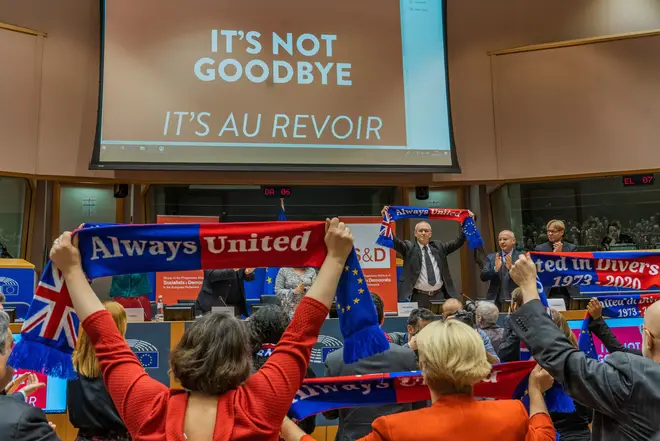 MEPs raised flags in the Parliament labelled "Always United"