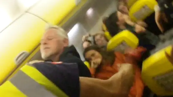 Have-a-go hero puts "drunk" passenger in a chokehold.