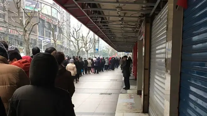 A queue outside a shop in Shanghai on Wednesday