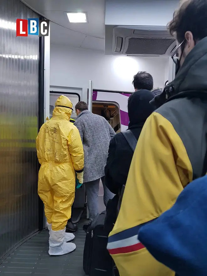 Passengers were greeted by staff in hazmat suits on their chartered flight back to the UK