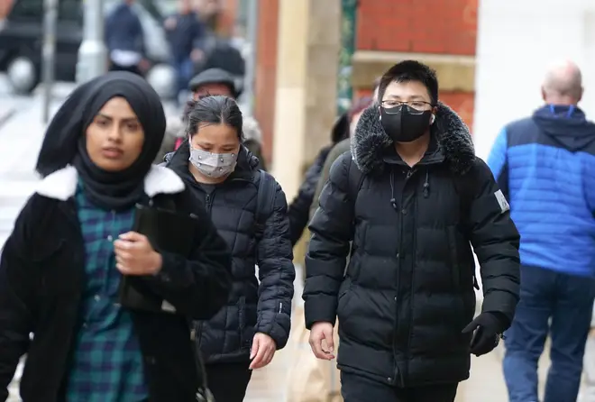 People wearing face masks in Manchester amid the coronavirus outbreak