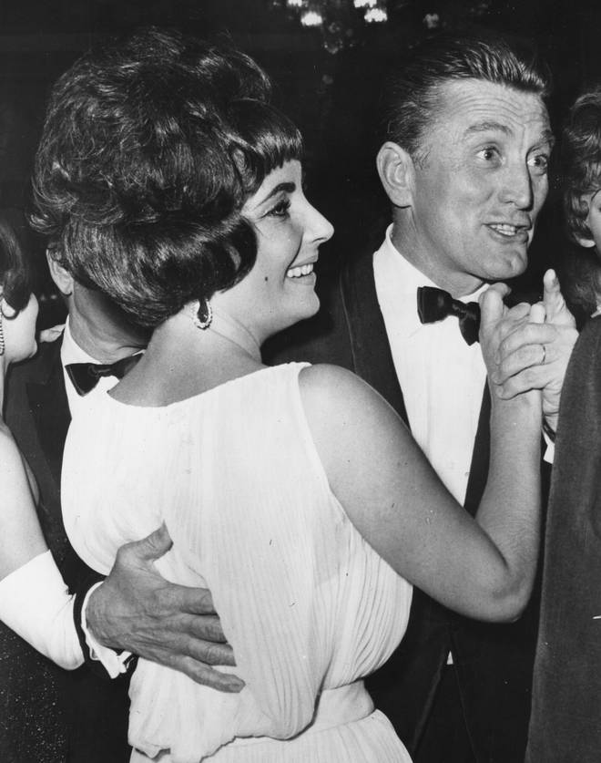 Elizabeth Taylor dancing with Kirk Douglas at the party in Rome for the film 'Spartacus'