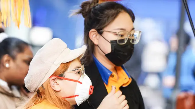 Women wear face masks as a precaution to the outbreak of Coronavirus in Central Manchester