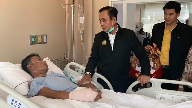 Thailand's Prime Minister Prayuth Chan-ocha visits the injured following a mass shooting