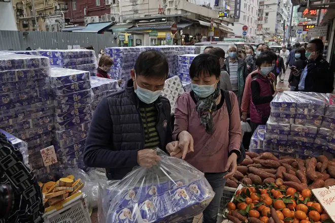 Hong Kong residents panic buy toilet tissue at a supermarket