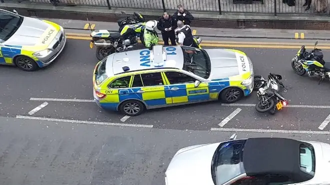 The police car nudged the thief while other officers chased him