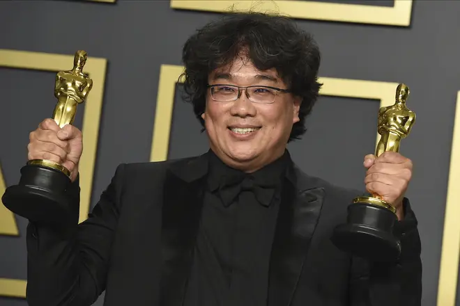 Bong Joon-ho celebrates after winning Best Director and Best Picture for Parasite