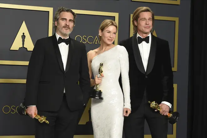 He poses with fellow winners Renee Zellweger and Brad Pitt